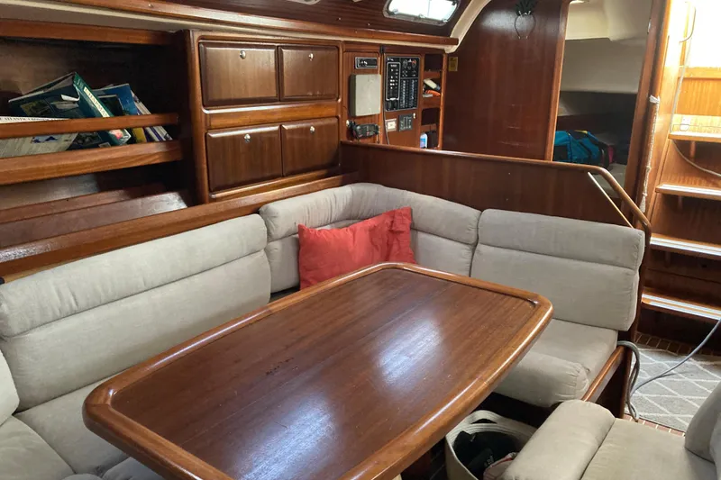Slide: The Image of Cozy interior of 2001 Bavaria 43 Cruiser sailboat with wooden table and cushioned seating. - 41