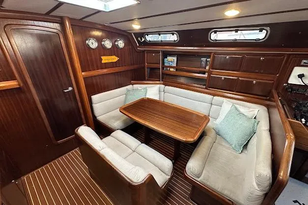 Slide: The Image of Interior of 2001 Bavaria 42 yacht with wooden furnishings and cozy seating area. - 44