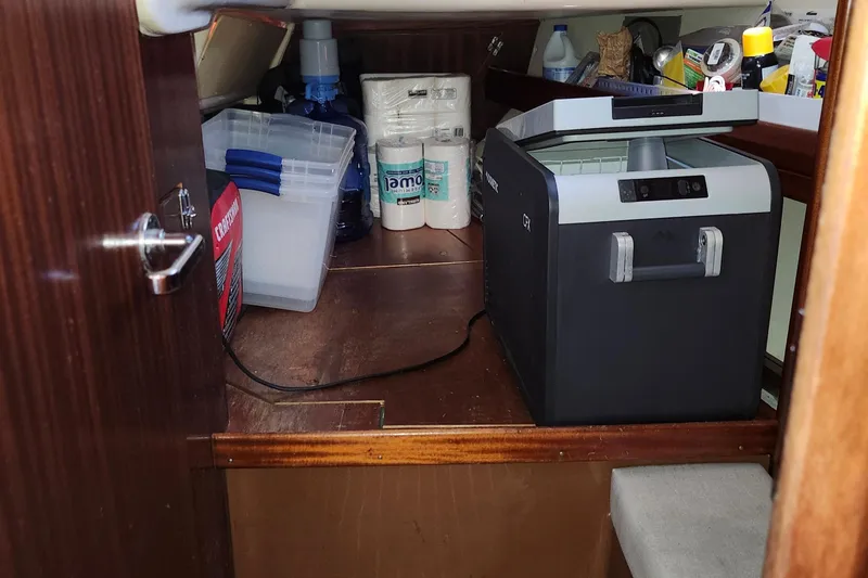 Slide: The Image of Storage area in a 2001 Bavaria 43 Cruiser with cooler and supplies. - 45