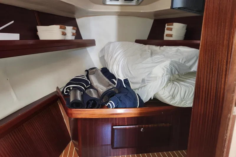 Slide: The Image of Cozy cabin interior of 2001 Bavaria 43 Cruiser with bedding and storage shelves. - 46