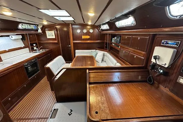 Slide: The Image of Interior of 2001 Bavaria 42 yacht with wooden finish and cozy seating area. - 48