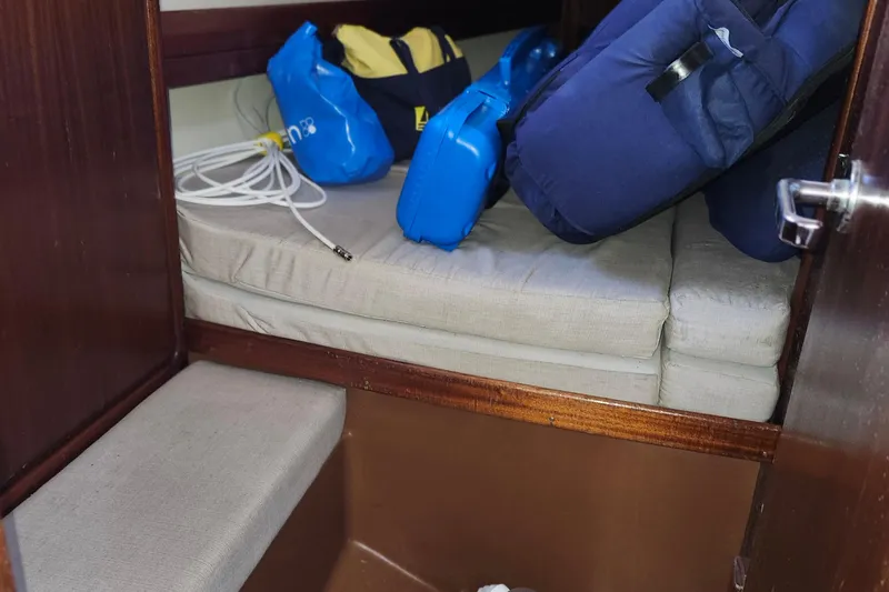Slide: The Image of Interior cabin of 2001 Bavaria 43 Cruiser with cushions and storage items. - 50