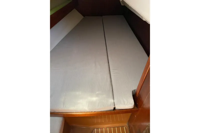 Slide: The Image of Interior cabin of 2001 Bavaria 43 Cruiser with gray cushions and wooden accents. - 53