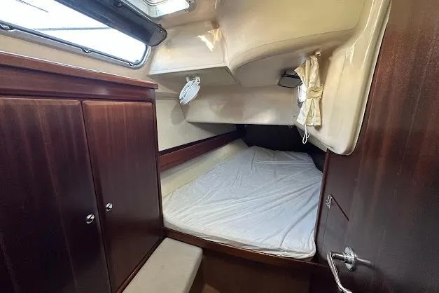 Slide: The Image of Cozy cabin interior of 2001 Bavaria 42 sailboat with wooden cabinetry and bed. - 54