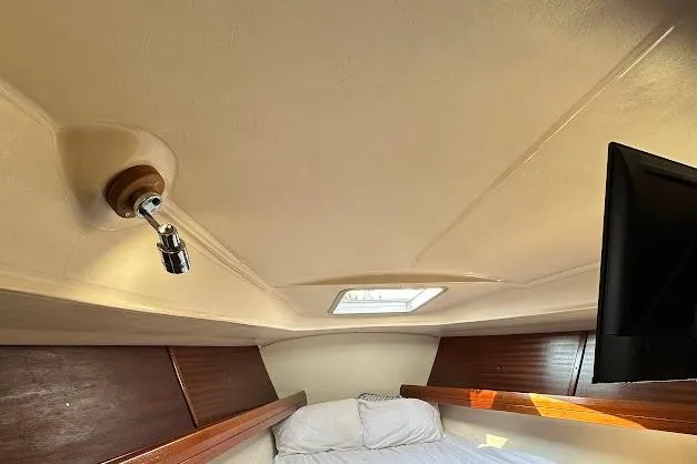 Slide: The Image of Cozy cabin interior of 2001 Bavaria 42 sailboat with bed and porthole. - 55