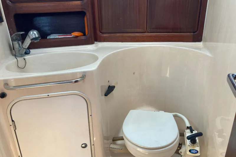Slide: The Image of Bathroom of 2001 Bavaria 43 Cruiser yacht with sink, storage, and marine toilet. - 58