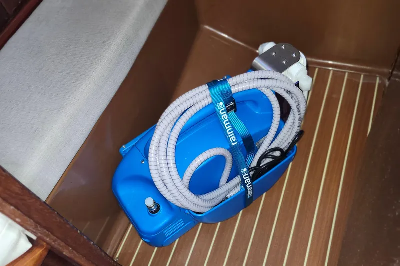 Slide: The Image of Blue watermaker unit on Bavaria 43 Cruiser 2001 yacht, secured with hose and strap. - 60
