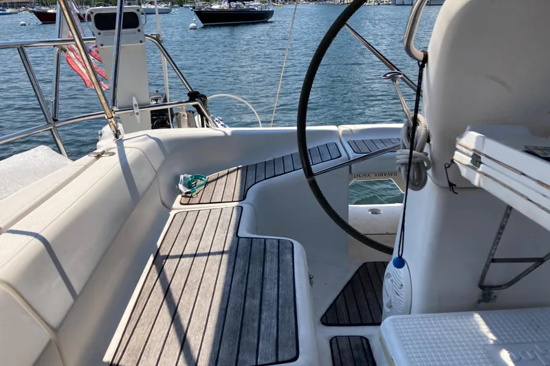 Slide: The Image of Cockpit of 2001 Bavaria 43 Cruiser sailboat with wooden seating and steering wheel. - 8