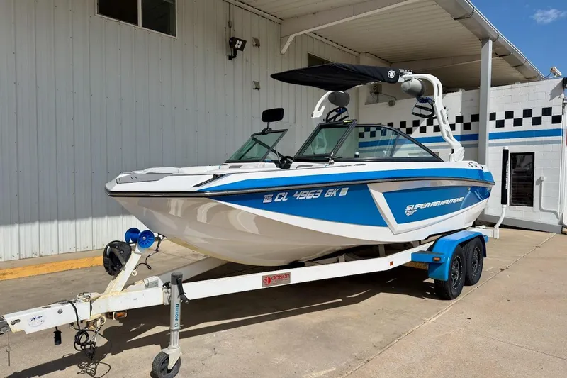 Slide: The Image of 2018 Nautique Super Air Nautique GS20 boat, rear view, parked outdoors under a clear sky. - 3