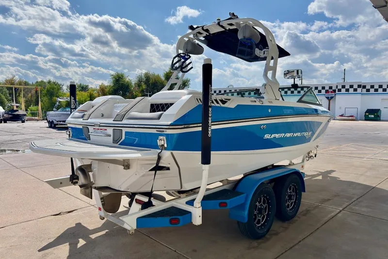 Slide: The Image of 2018 Nautique Super Air Nautique GS20 boat interior with steering wheel and seating. - 7