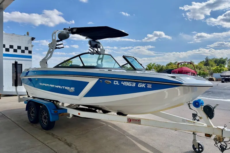 Slide: The Image of 2018 Nautique Super Air Nautique GS20 boat interior with white and blue seating. - 9