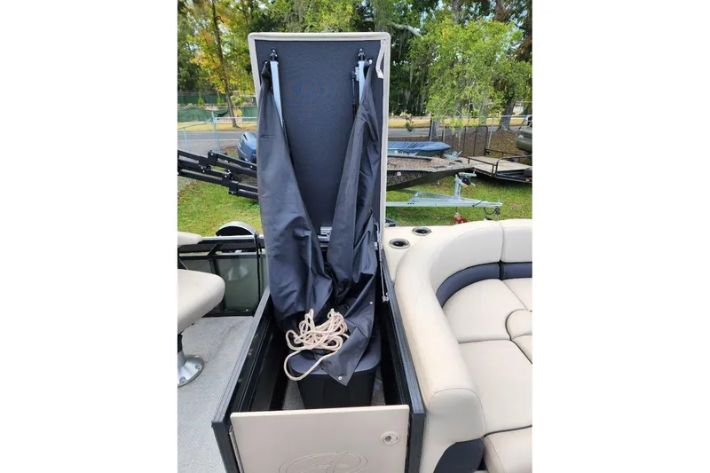 Slide: The Image of 2022 Avalon GS Rear Fish boat storage compartment with cover and rope. - 10
