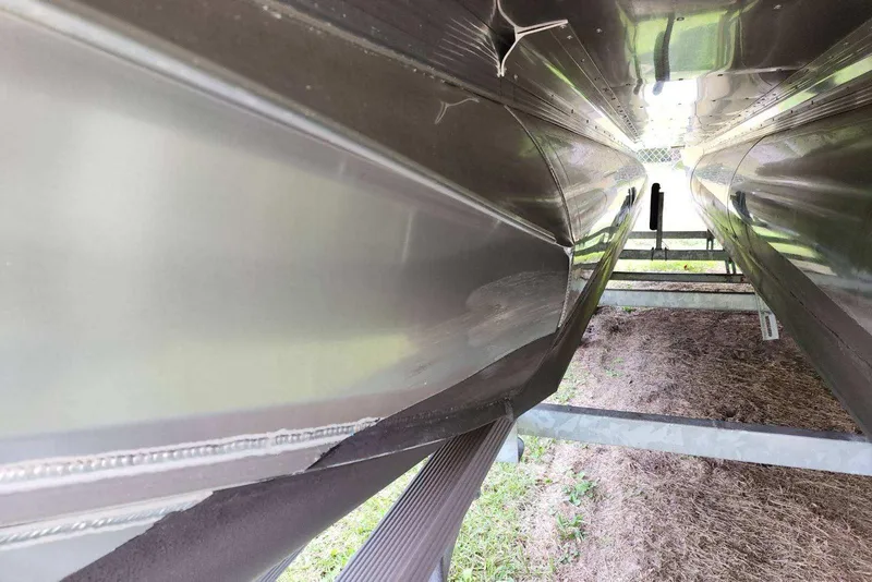 Slide: The Image of Underneath view of 2022 Avalon GS Rear Fish 23' pontoon boat on trailer. - 13