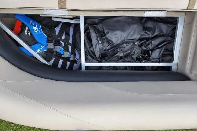 Slide: The Image of Storage compartment in 2022 Avalon GS Rear Fish boat with life jackets and gear. - 15