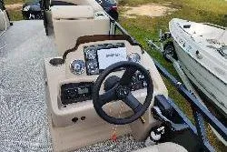 Slide: The Image of 2022 Avalon GS Rear Fish boat dashboard with steering wheel and controls. - 21