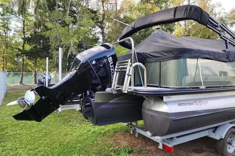 Slide: The Image of 2022 Avalon GS Rear Fish 23' pontoon boat with Suzuki outboard motor on trailer. - 5