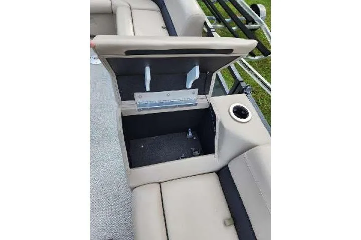 Slide: The Image of Open storage compartment in 2022 Avalon GS Rear Fish boat with beige seating. - 7