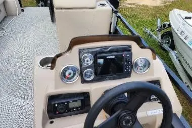 Slide: The Image of 2022 Avalon GS Rear Fish boat dashboard with steering wheel and control panel. - 9