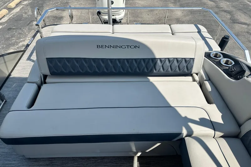 Slide: The Image of 2023 Bennington Q25 boat seating with cup holders and elegant upholstery design. - 13