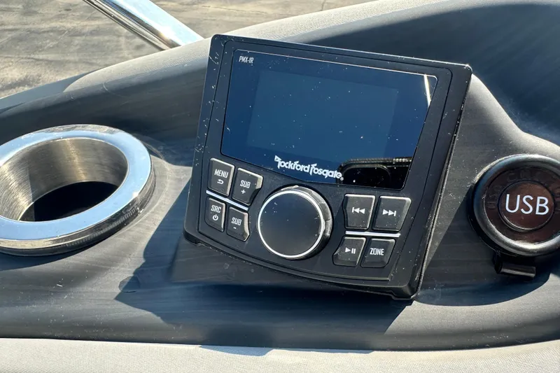 Slide: The Image of Dashboard of 2023 Bennington Q25 with Rockford Fosgate audio system and USB port. - 14