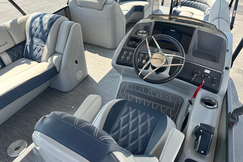 Slide: The Image of 2023 Bennington Q25 boat interior with luxurious seating and modern steering console. - 5