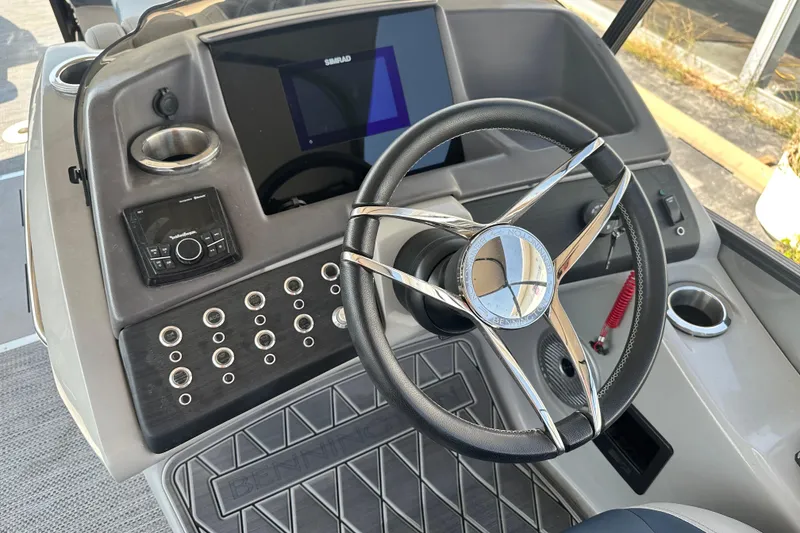 Slide: The Image of 2023 Bennington Q25 boat dashboard with steering wheel and control panel. - 6