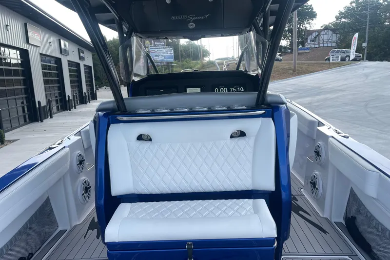 Slide: The Image of 2022 Nor-Tech 340 Sport Center Console boat with white seating and modern dashboard. - 11