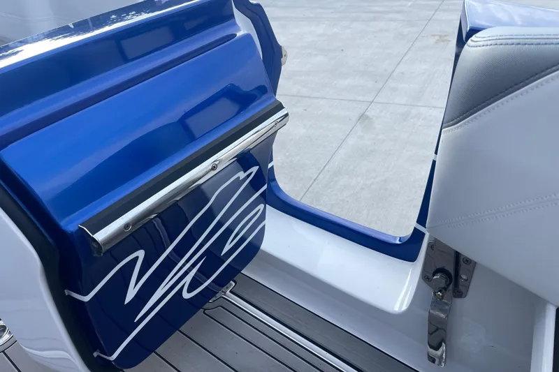 Slide: The Image of 2022 Nor-Tech 340 Sport Center Console boat door with sleek blue and white design. - 14