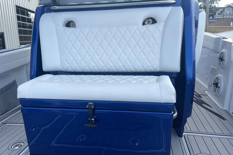 Slide: The Image of 2022 Nor-Tech 340 Sport Center Console with white diamond-stitched seating and blue accents. - 15