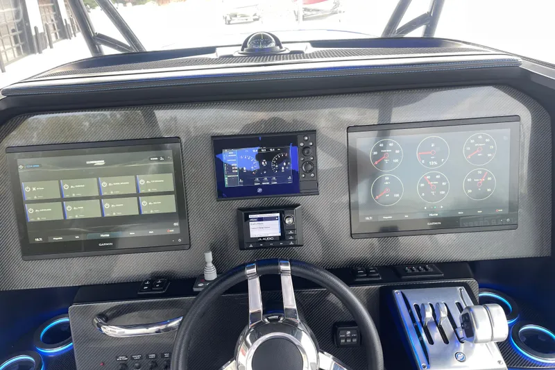 Slide: The Image of Dashboard of 2022 Nor-Tech 340 Sport Center Console with advanced Garmin displays and controls. - 19