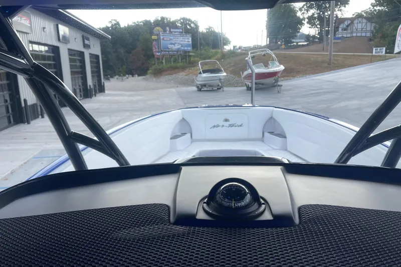 Slide: The Image of 2022 Nor-Tech 340 Sport Center Console boat at a marina, view from helm. - 20