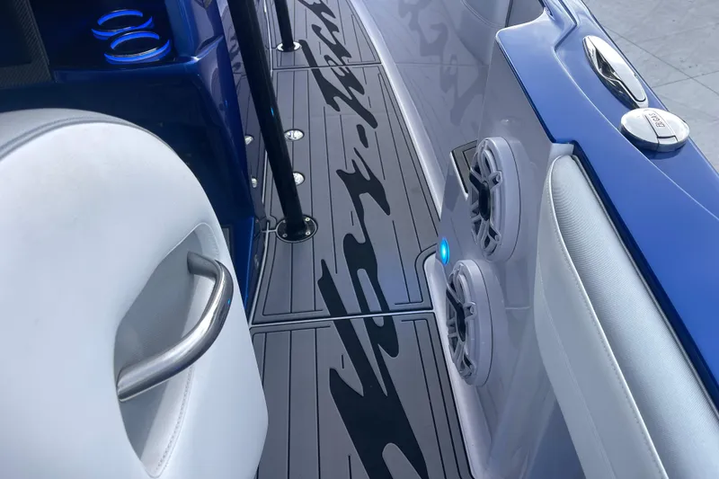 Slide: The Image of 2022 Nor-Tech 340 Sport Center Console interior with sleek design, speakers, and cup holders. - 21