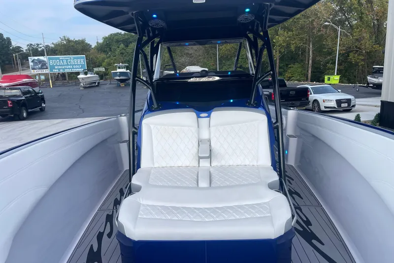 Slide: The Image of 2022 Nor-Tech 340 Sport Center Console boat with white seating and sleek design. - 22
