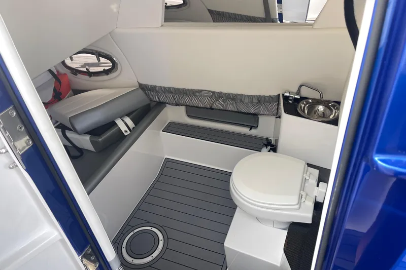 Slide: The Image of 2022 Nor-Tech 340 Sport Center Console interior with toilet and sink. - 25