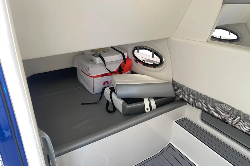 Slide: The Image of 2022 Nor-Tech 340 Sport Center Console cabin with life jackets and storage. - 26