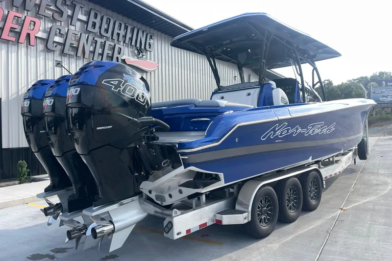 Slide: The Image of 2022 Nor-Tech 340 Sport Center Console boat with triple Mercury 400R engines on trailer. - 3