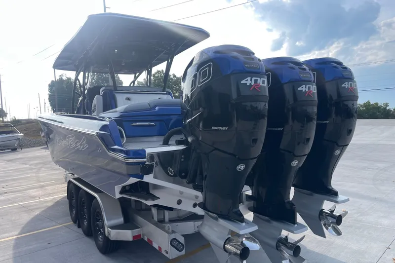 Slide: The Image of 2022 Nor-Tech 340 Sport Center Console with triple Mercury 400R engines on trailer. - 5