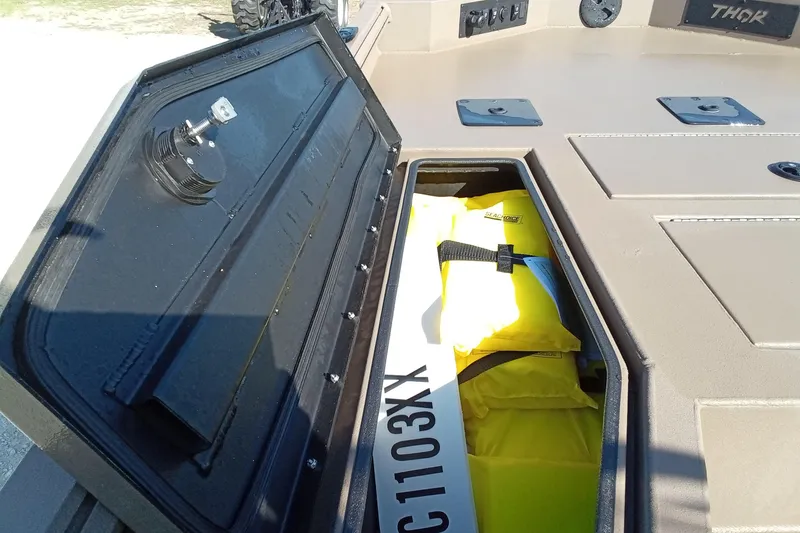 Slide: The Image of Open storage compartment on 2025 Thor 1900 Lake Hammer boat with life jackets inside. - 13