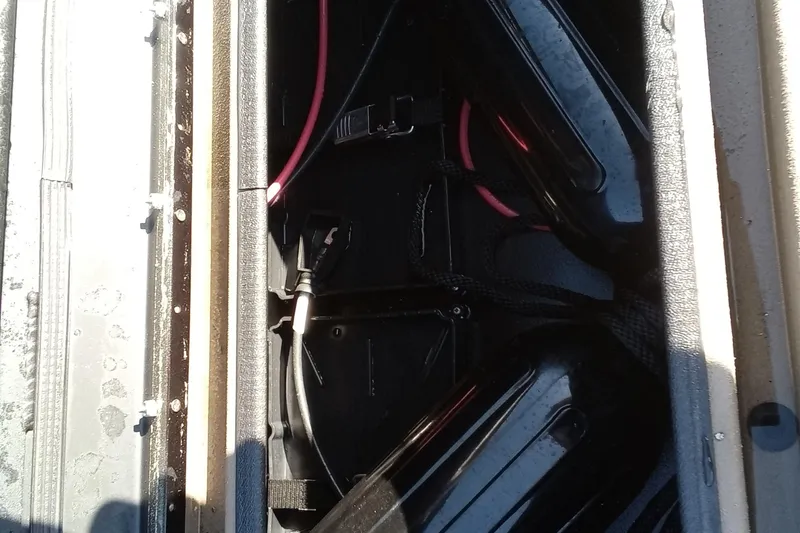 Slide: The Image of Battery compartment of 2025 Thor 1900 Lake Hammer with visible wiring and components. - 14