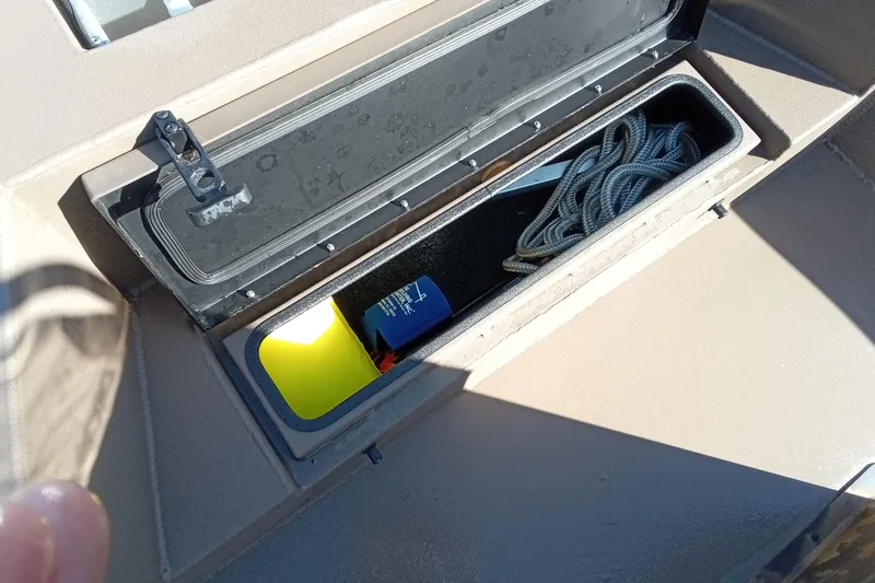 Slide: The Image of Open storage compartment in 2025 Thor 1900 Lake Hammer boat with rope and safety gear. - 16