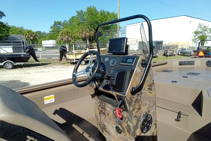 Slide: The Image of Control panel of 2025 Thor 1900 Lake Hammer boat with steering wheel and navigation equipment. - 9