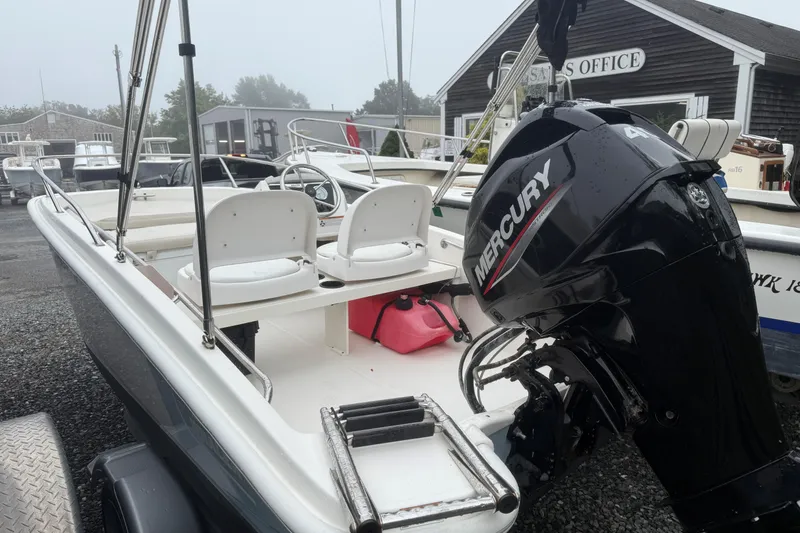 Slide: The Image of 2020 Boston Whaler 130 Super Sport boat with Mercury engine at sales office. - 2