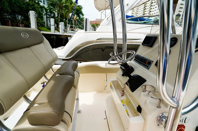 Slide: The Image of 2022 Key West 219 FS boat interior with steering wheel and control panel. - 14