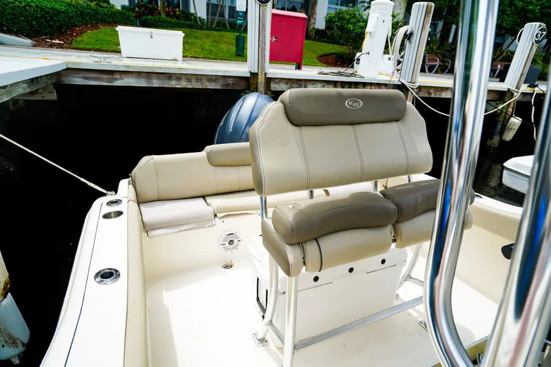 Slide: The Image of 2022 Key West 219 FS boat interior with beige seating at dock. - 16