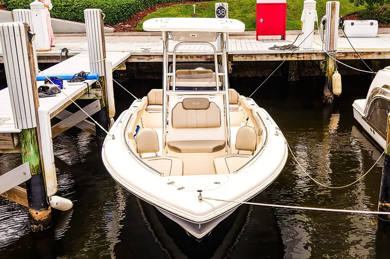 Slide: The Image of 2022 Key West 219 FS boat docked at marina, featuring sleek design and comfortable seating. - 2