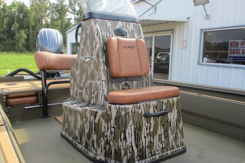 Slide: The Image of 2026 Avid 20 ROGUE CC boat with camo design and brown seating. - 10