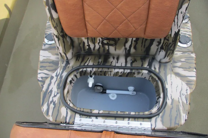 Slide: The Image of Avid 20 ROGUE CC 2026 boat with camo design and brown seating. - 12