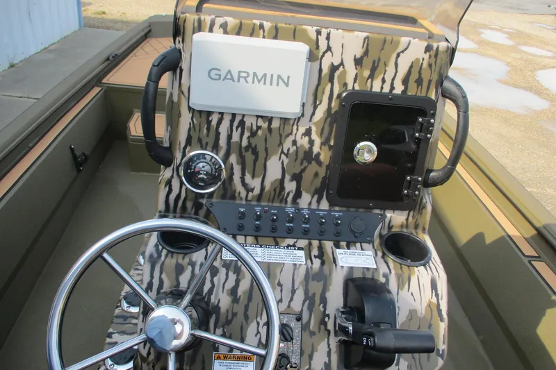 Slide: The Image of 2026 Avid 20 ROGUE CC boat dashboard with Garmin navigation system and camouflage design. - 13