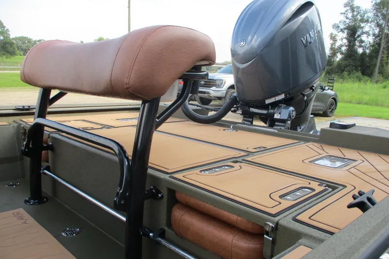 Slide: The Image of 2026 Avid 20 ROGUE CC boat interior with Yamaha outboard motor, featuring brown seating. - 15