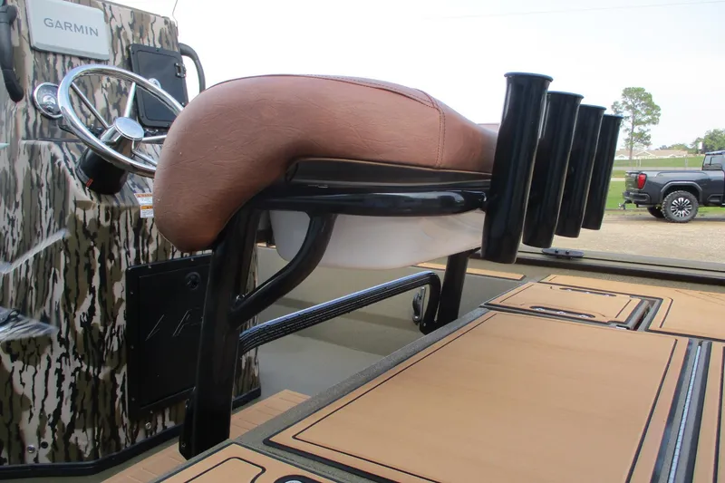 Slide: The Image of 2026 Avid 20 ROGUE CC boat interior with steering wheel and rod holders. - 16